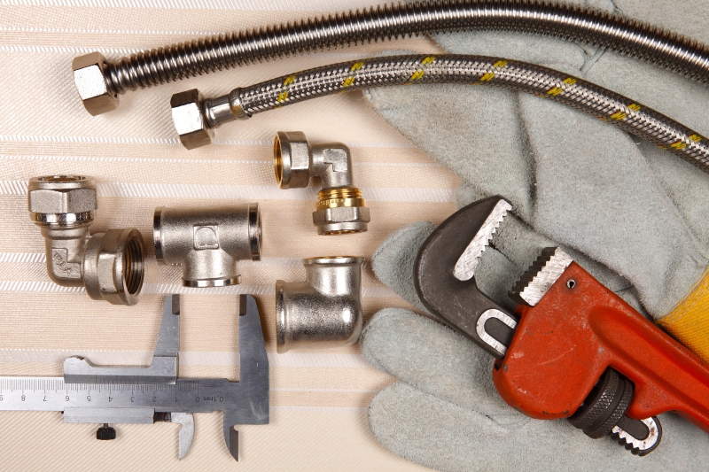 Plumber working on pipes in a Goffs Oak home